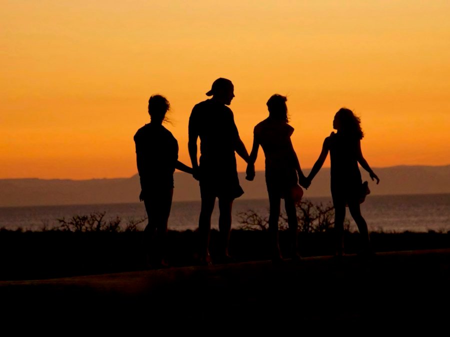 Family silhouettes at sunset