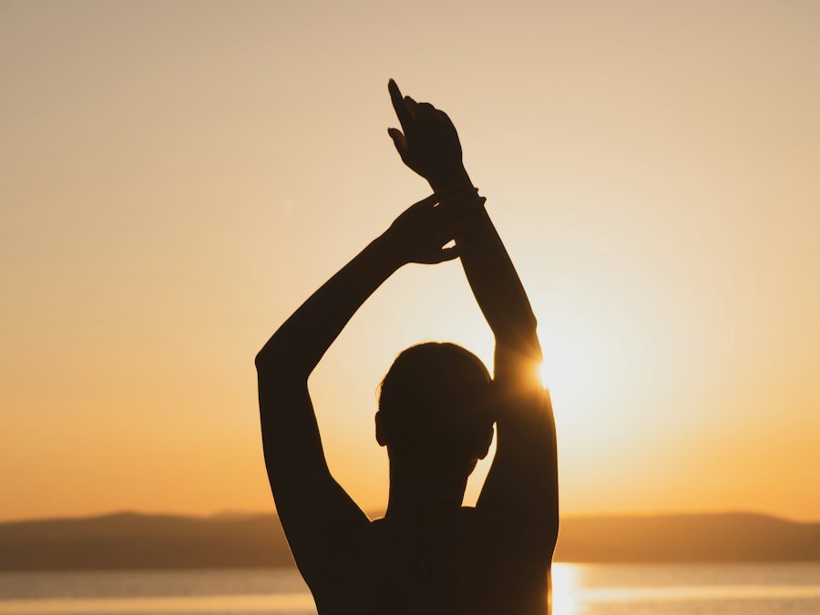 Person stretching at sunrise