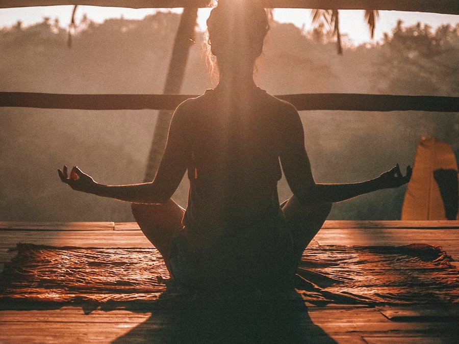 Woman in yoga pose at sunset