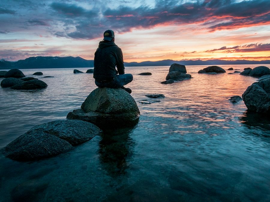 Person meditating by the sea